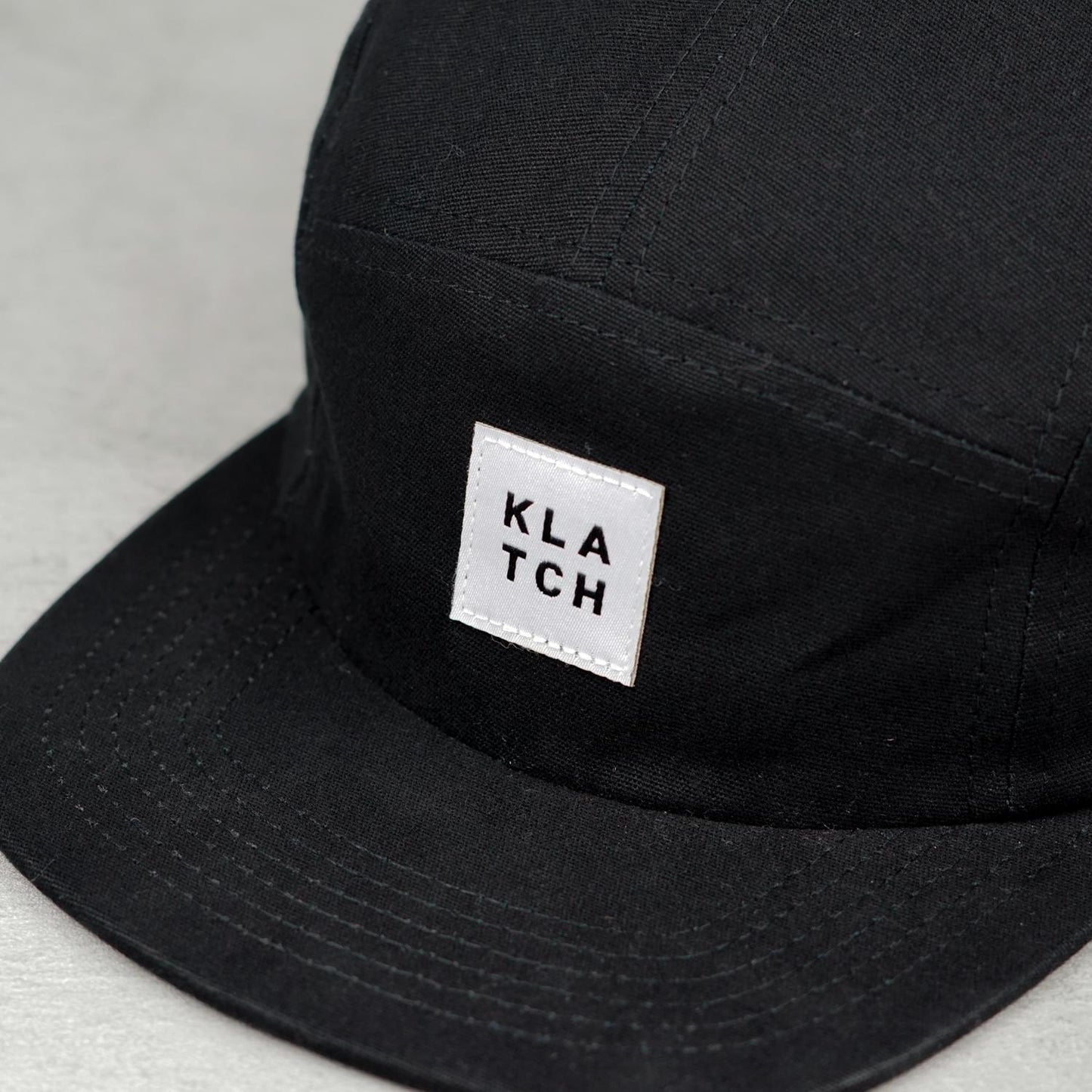 white woven label on five panel hat