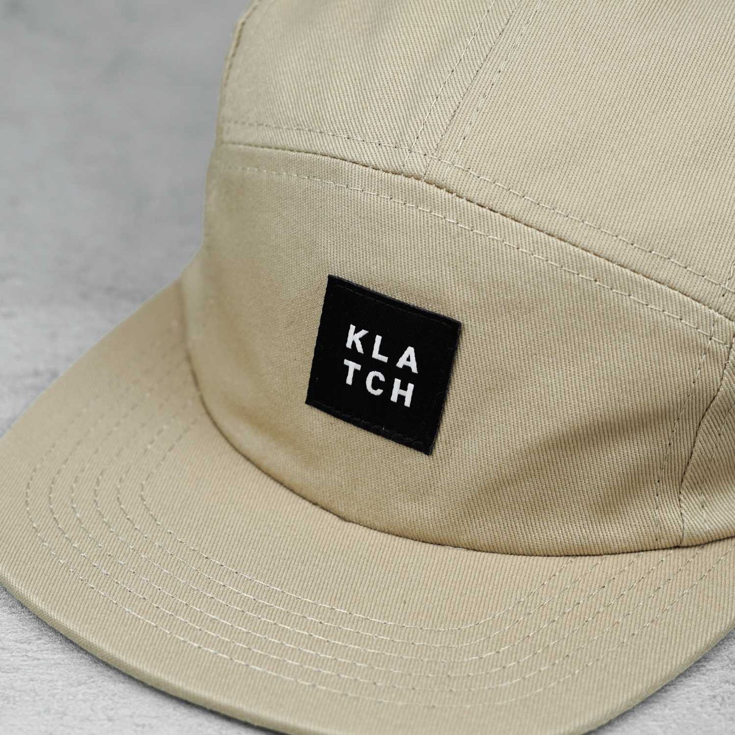 woven label on tan five panel hat