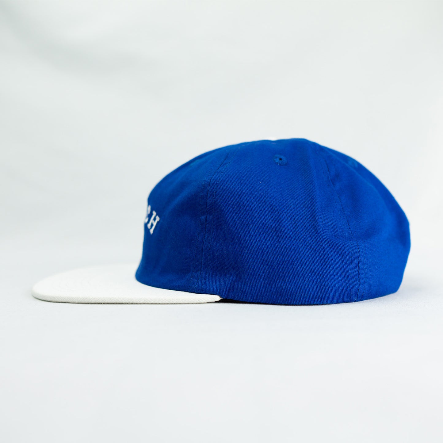 klatch co campbell snapback cap in navy and white left view